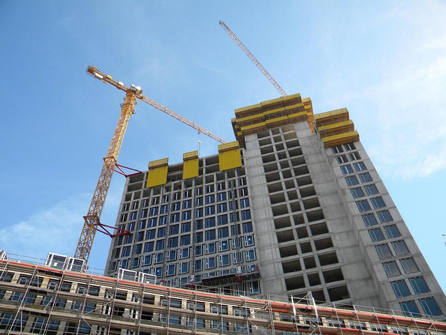 Multi-storey building under construction with cranes